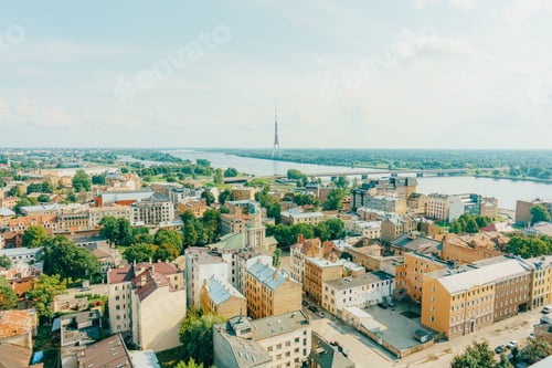 Preview: Aerial view of Riga cityscape with the Daugava River and Riga Radio and TV Tower under a clear sky