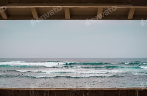 Preview: Panoramic view of people surfing at Hookipa Beach, Maui on a cloudy day