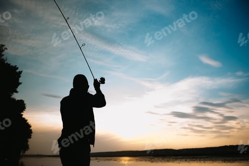Preview: Fishing. spinning at sunset. Silhouette of a fisherman.
