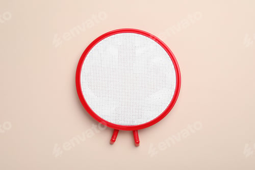 Preview: Embroidery hoop with fabric on beige background, top view