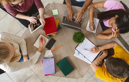 Preview: Group of international students sitting at table, top view