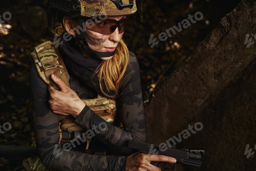 Preview: Serious woman holding hand firearms for shooting