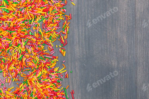 Preview: Pile of colorful sprinkles on dark surface