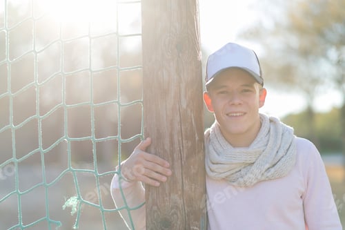 Preview: Portrait of a smiling young man wearing a cap