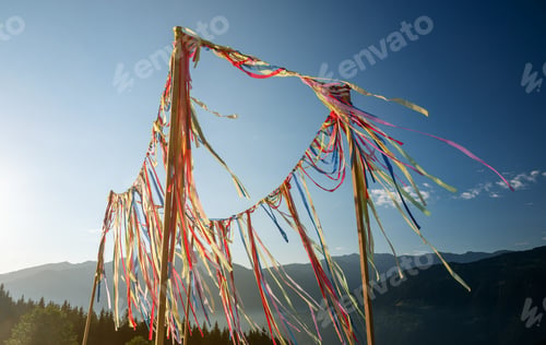 Preview: Multicolored ribbons or garlands flutter in the wind on a summer sunny day with a blue sky