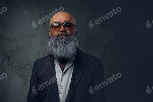 Preview: Bearded elderly hipster with sunglasses against dark background