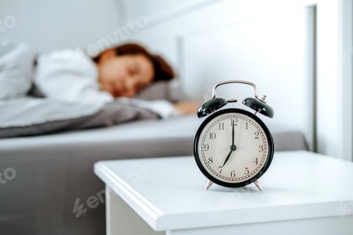 Preview: Close up Clock on the bed Asian woman wake up and disturbed by alarm clock early morning