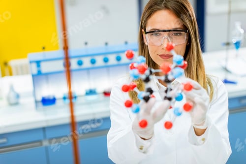 Preview: Female chemist hold molecular model in the lab