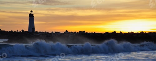 Preview: Waves crash on the shoreline by the lighthouse at the Santa Cruz harbor at sunset
