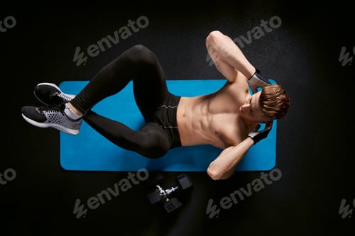 Preview: Shirtless man training abs on mat
