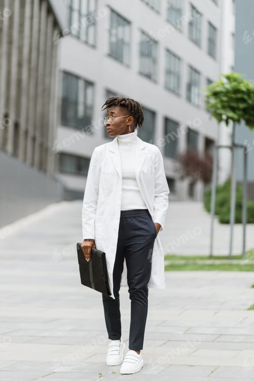 Preview: Portrait of young smart focused african female medical intern doctor with folder clipboard