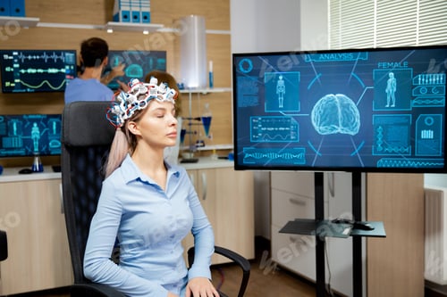 Preview: Female patient who is in a neurology clinic and her brain is being scanned