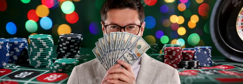 Preview: Gambler with money fan, casino chips and roulette table. Banner design