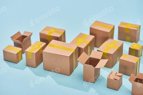 Preview: postal cardboard boxes on blue background with copy space