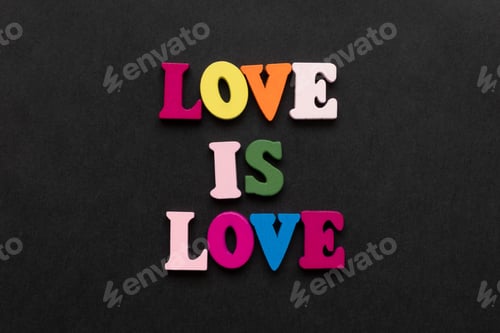 Preview: words love is love, notepad with chalk drawn heart. Valentine's day concept