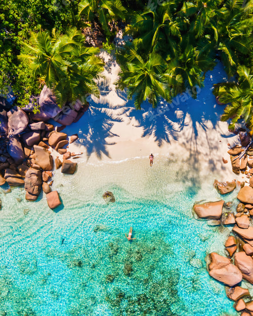Preview: Praslin Seychelles tropical island with withe beaches and palm trees, couple men and women mid age