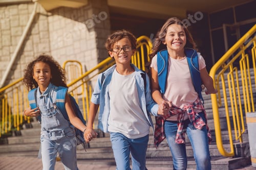 Preview: Happy kids elementary school pupils children with rucksacks