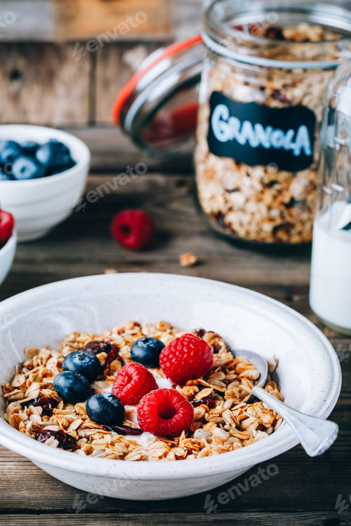 Preview: Healthy breakfast bowl. Homemade granola with natural yoghurt, blueberries and raspberries