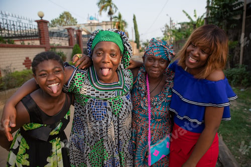 Preview: Four african women of different ages together laugh and make funny faces