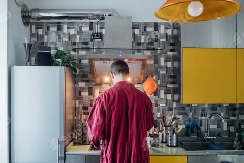 Vista previa: Adult man indoor at home kitchen preparing food or coffee