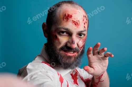 Preview: Halloween zombie taking picture on smartphone
