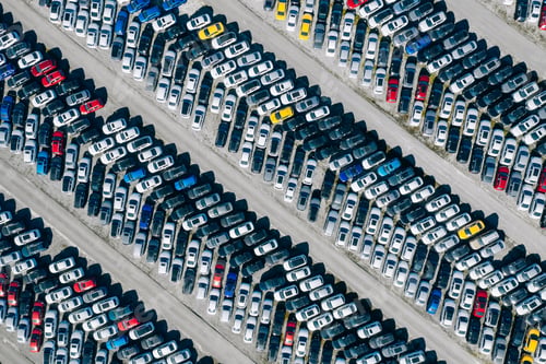 Preview: Aerial drone view of Parking lot. New cars storage area. Many cars parked in a rows
