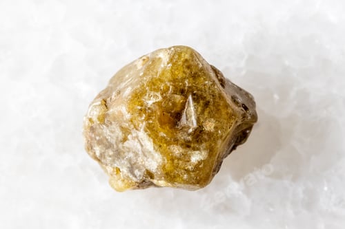 Preview: rough single grossular garnet crystal on white