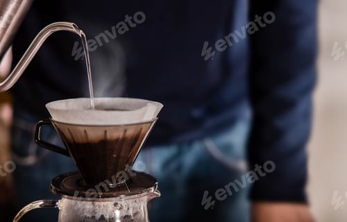 Preview: Person Dripping Coffee at Home in the Morning.Pouring Hot Water from Kettle to a Dripper