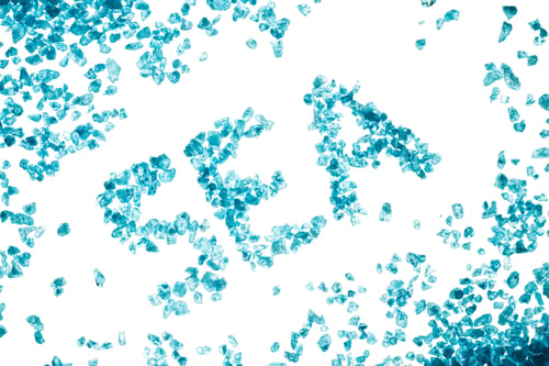 Preview: Blue crystals of sea salt and inscription SEA on white background