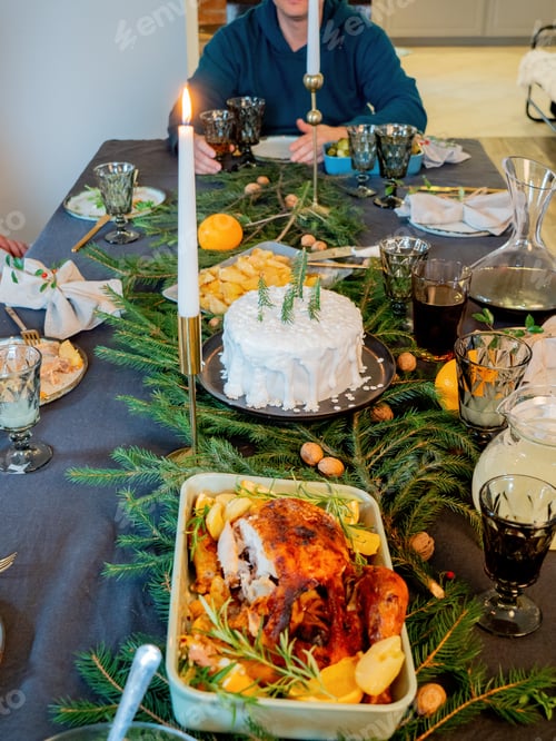 Preview: family sits at christmas table full of food