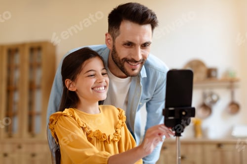 Preview: Smiling Girl and Man Looking at Cellphone