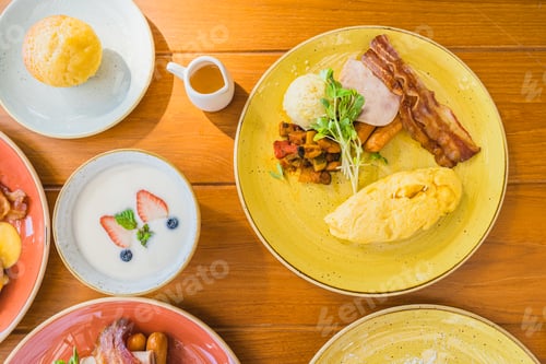Preview: Fried egg with eggs benedict and omelette around bacaon ham sausage in plate