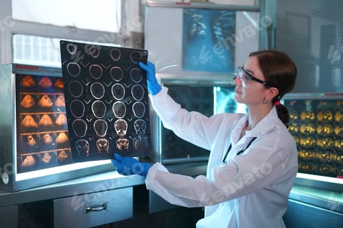 Preview: Portrait of young doctor checking X-Ray in hospital to make diagnosis