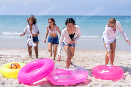 Preview: Teenage girl friendship enjoy laughing play on the blue sky sea and run to get water inflation toy