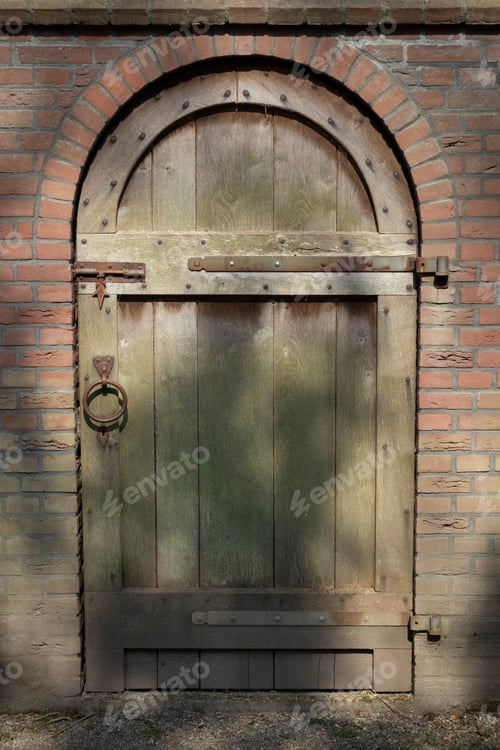 Preview: Old classic wooden door in a stone wall