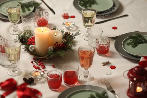 Preview: Christmas table with candles, drinks, pine branches and festive decor for holiday celebration