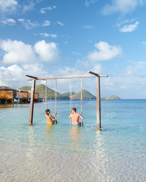 Preview: Couple in a swing on the beach of the tropical Island Saint Lucia or St Lucia Caribbean