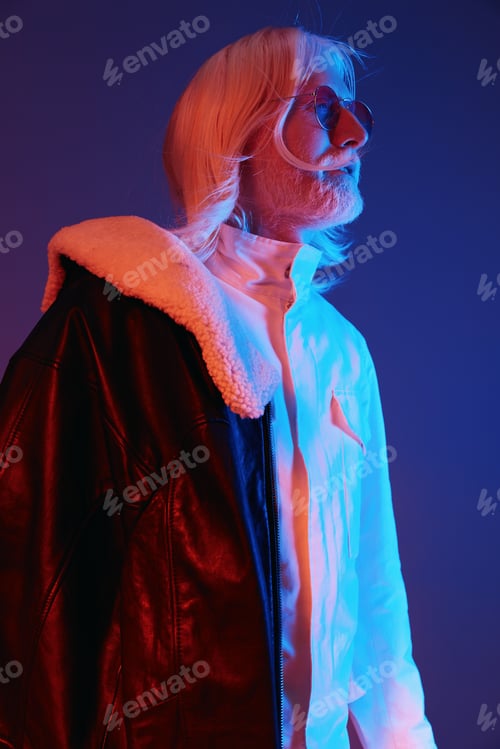 Preview: Stylish senior man with long white hair in a trendy outfit, wearing a leather jacket over a stylish