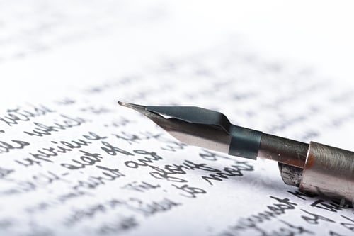 Preview: Close up of a writing pen on paper with hand written text