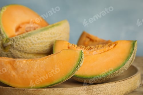 Preview: Tasty fresh cut melons on wooden tray, closeup