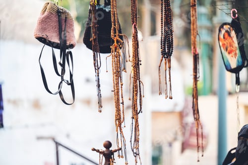 Preview: Scenic view of jewelry and bags hanging in the shop on a blurred background