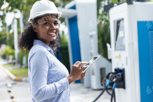 Preview: A female engineer checking modern charging equipment