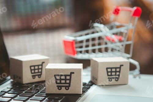 Preview: Shopping online. cardboard box with a shopping cart logo in a trolley on laptop keyboard.