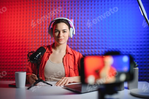 Preview: Young woman blogger recording video on camera