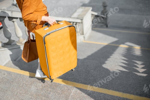 Preview: Woman traveling with a suitcase in the old city