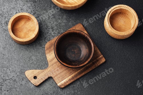 Preview: Wooden containers and a small bowl on a cutting board in a kitchen setting