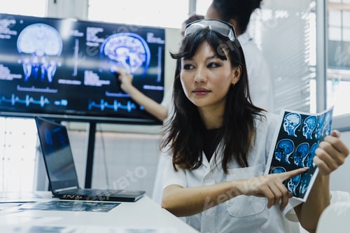 Preview: Team of female doctor check on scan results paper and looking at monitors in laboratory