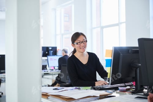 Preview: Woman working in office, using computer