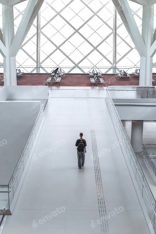 Preview: Travel, airport, woman waiting for a flight working on the phone, solo travel, airport transit area,