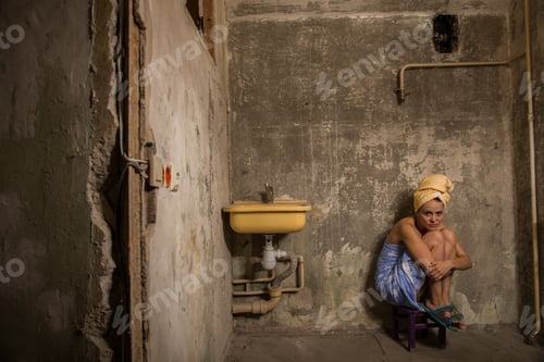 Preview: Cheap Accommodation. A Girl Sits On A Chair In An Old Apartment